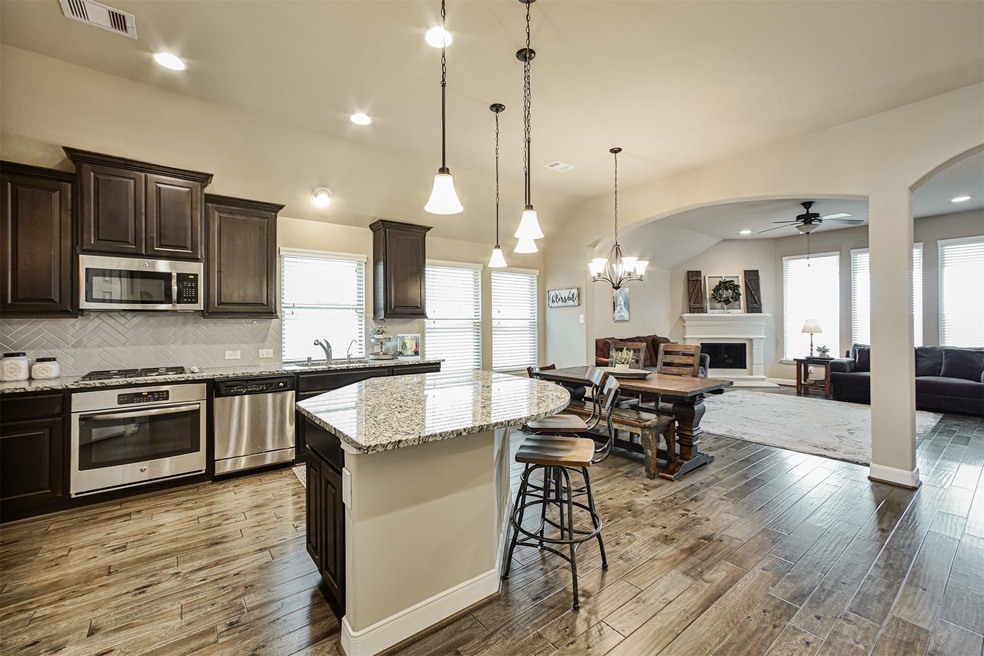 Welcome to 2322 Falcon Brook! The Kitchen is an entertainer's DREAM and the open floor plan creates a warm and inviting home for families and entertaining.  The open Kitchen features an over-sized Kitchen Island, beautiful 42