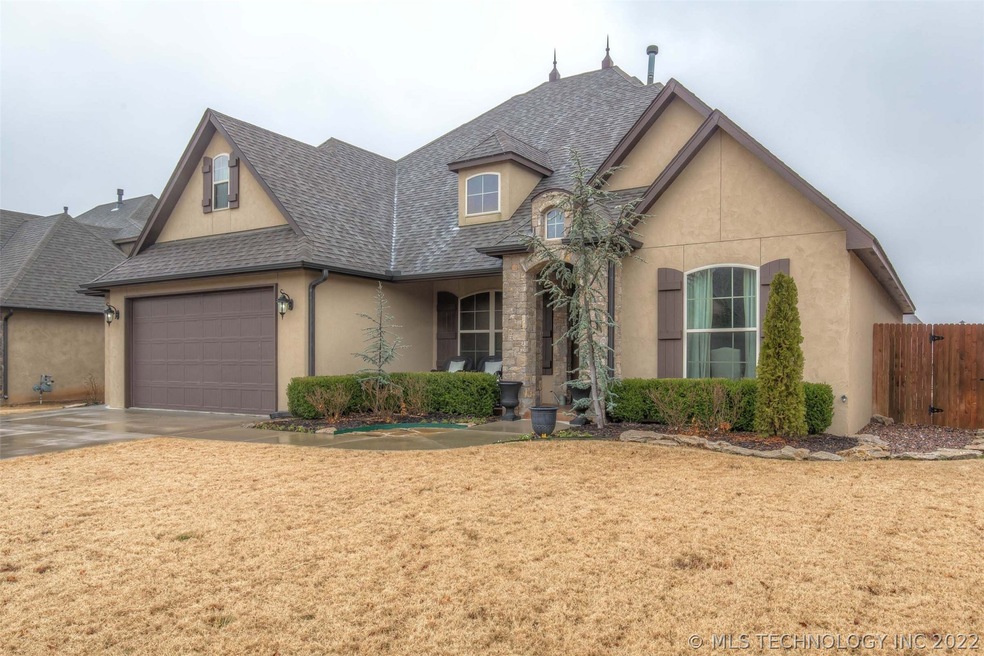 Stucco and stone front elevation.