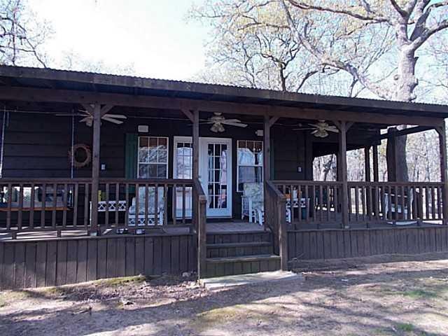 Exterior Front. Cabin #1 wrap-a-round porch overlo