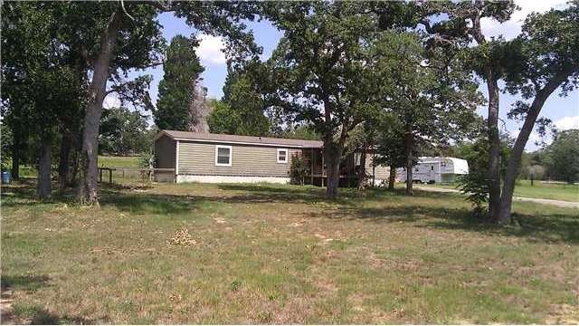 Frontage : View from the road. Large trees with sc