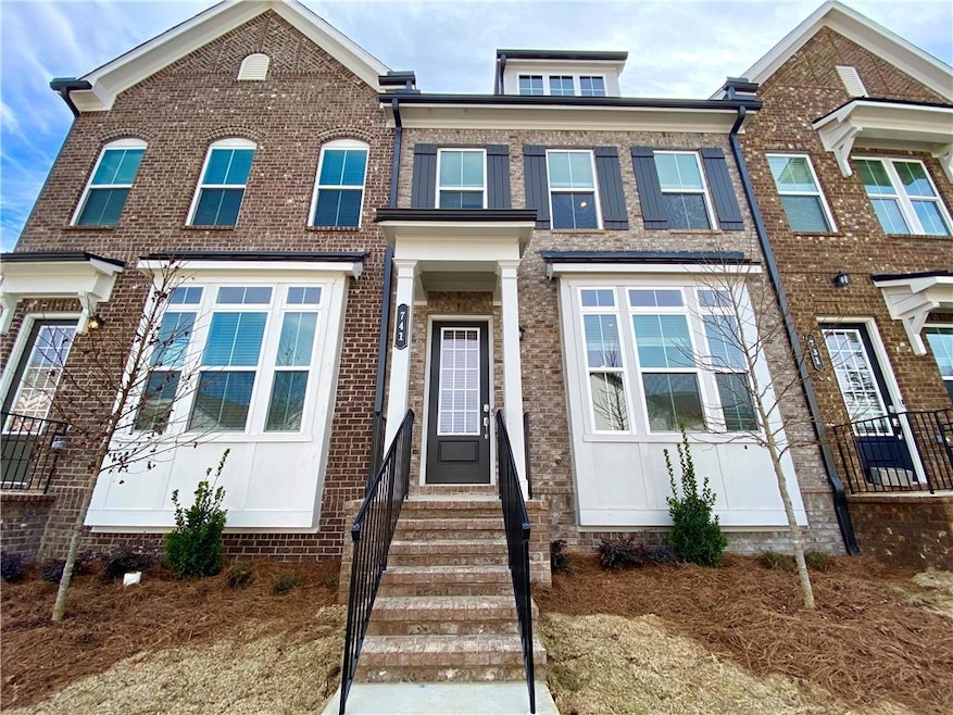 View of front of house with entry steps and brick siding