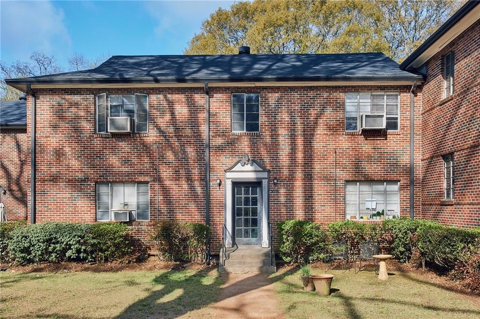 View of front of house with brick siding and cooli