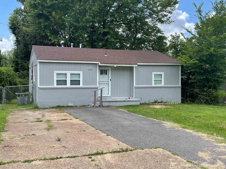 View of front facade featuring brick siding, a shingled roof, and crawl space
