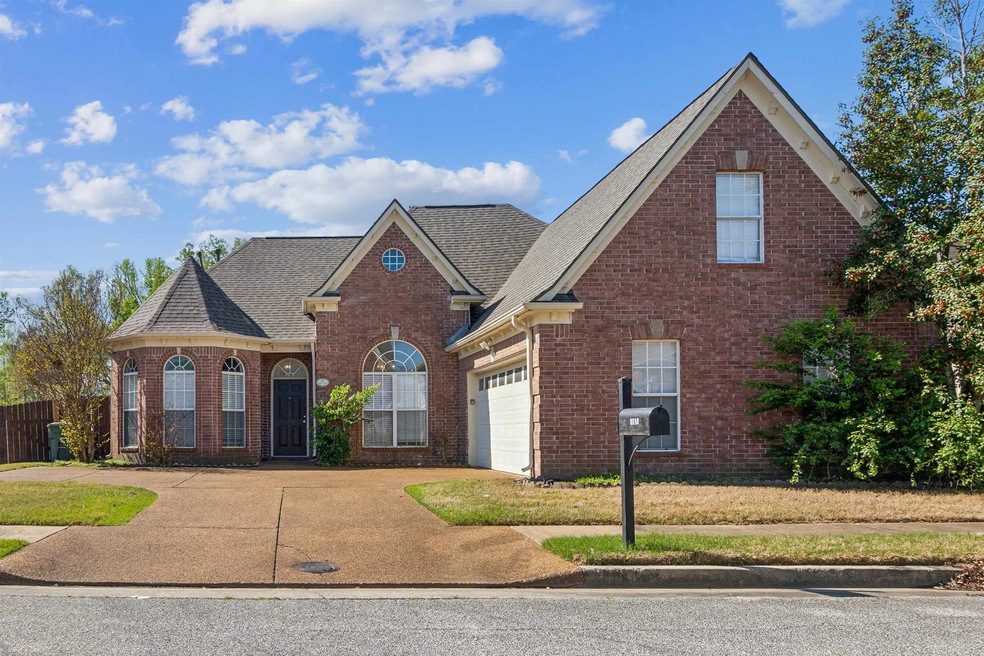 Traditional home with roof with shingles, brick si