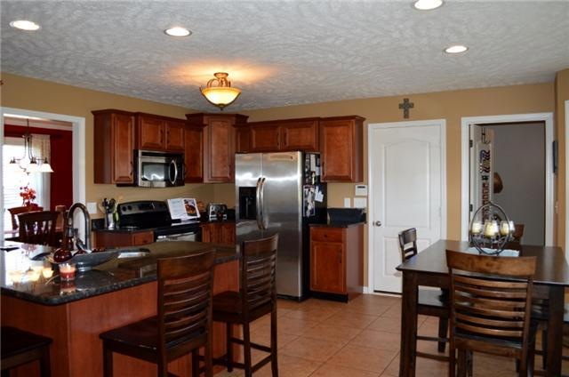 Large kitchen with stainless steel appliances! Breakfast bar and an eat-in area!