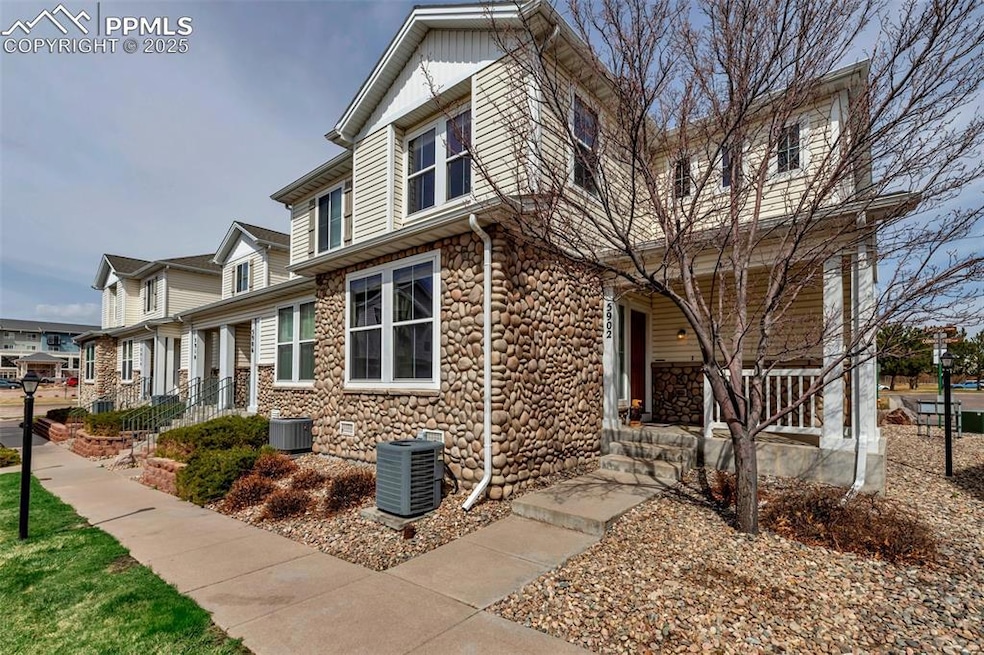 View of side of home featuring a porch, central AC