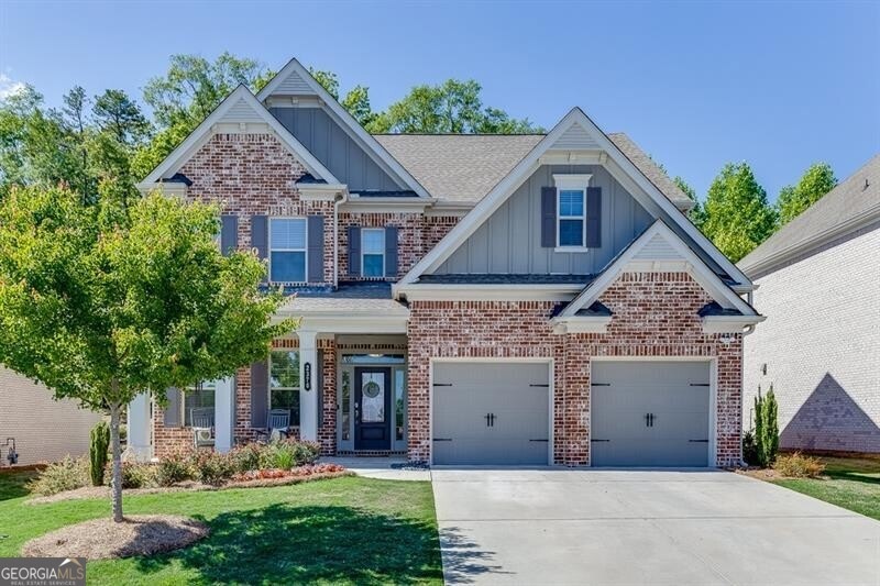 Craftsman-style home featuring a garage and a fron