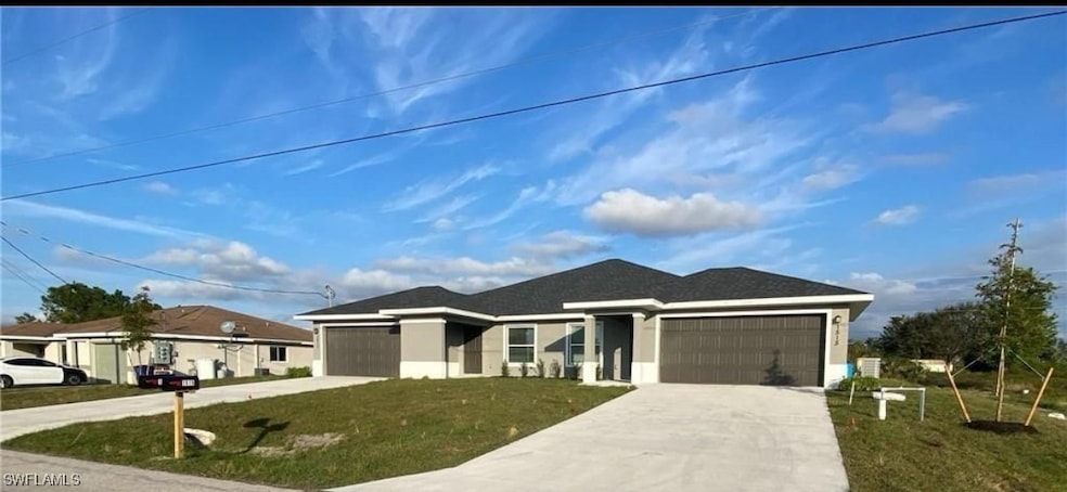 View of front of home with driveway, a garage, a f