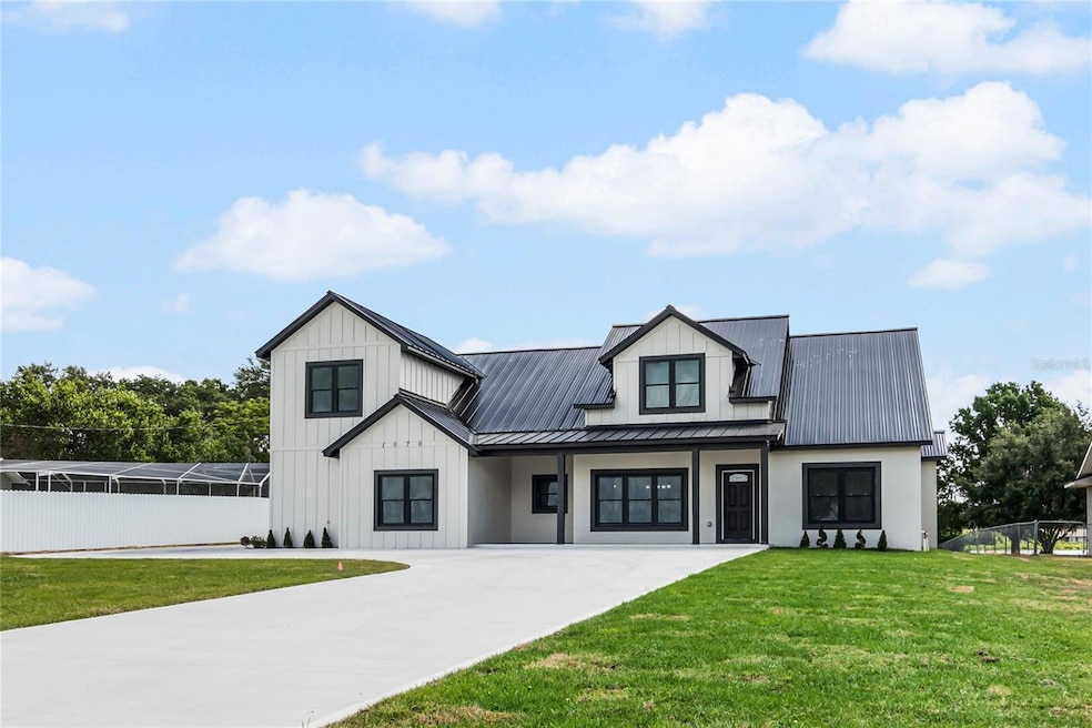 Stunning modern house with a sleek metal roof and clean architectural lines, nestled in a tranquil setting with lush greenery.
