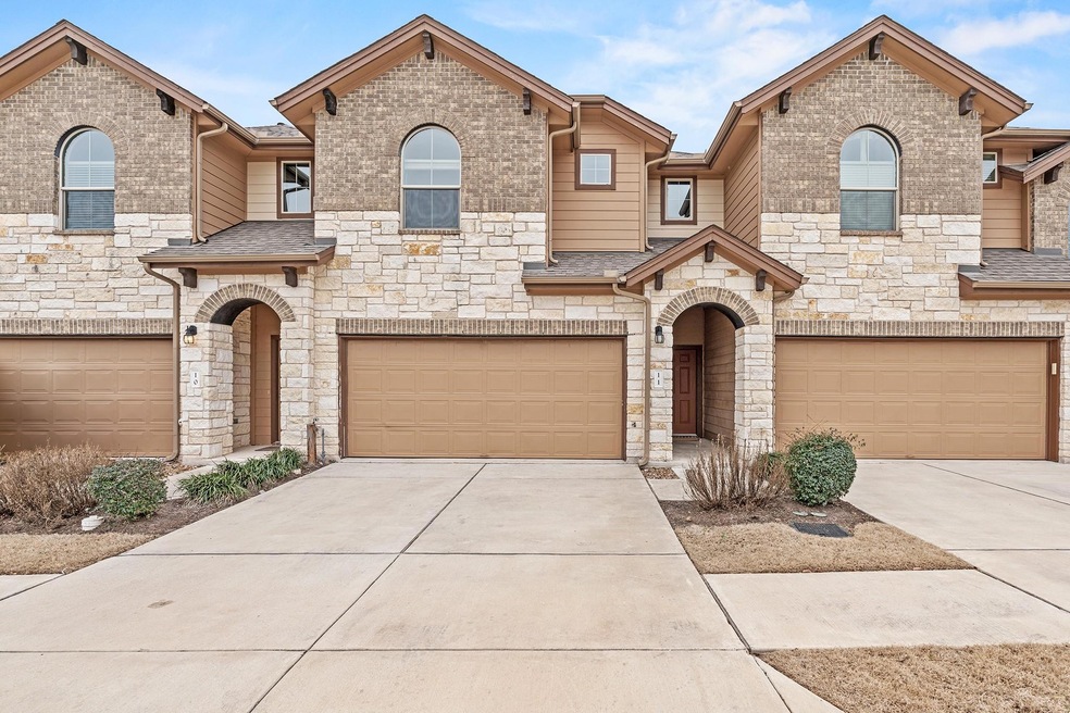 View of front of house with a garage, driveway, a
