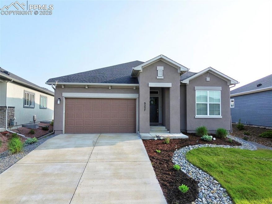 View of front of property with stucco siding, concrete driveway, and a garage