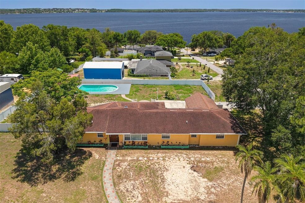 Breathtaking aerial shot showcasing the expansive backyard oasis, resort-style saltwater pool, oversized lot, and unobstructed views of the majestic Lake Minnehaha—your private slice of paradise.