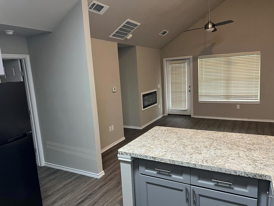 Kitchen with gray cabinets, ceiling fan, dark hard