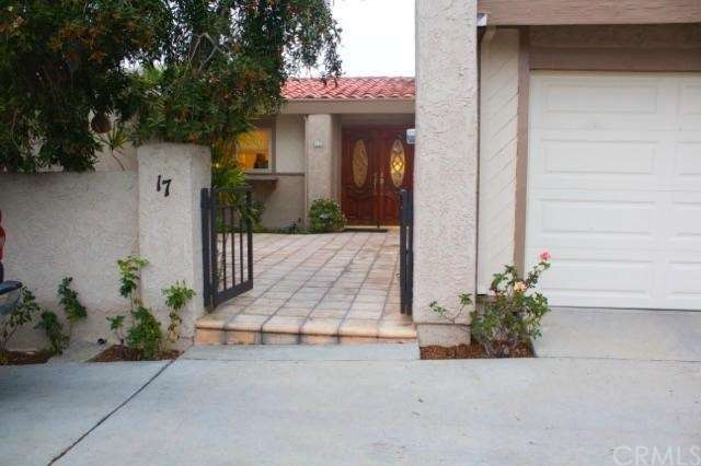Front of townhome with large front patio and doubl