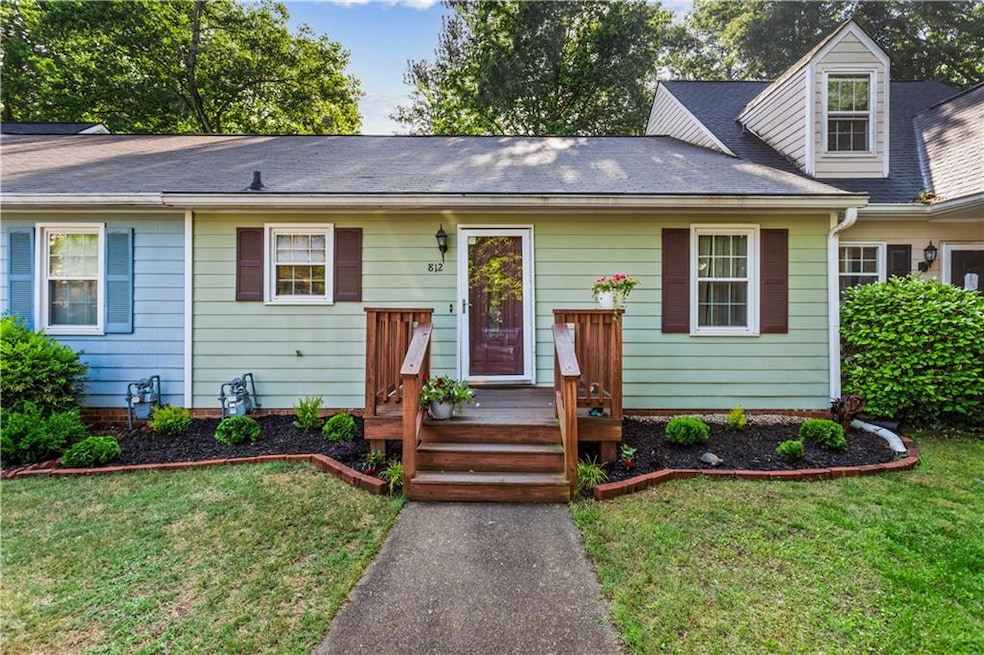 View of front facade with a front yard and roof wi