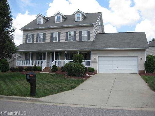Exterior Front. Rocking chair front porch overlooks well manicured front lawn.