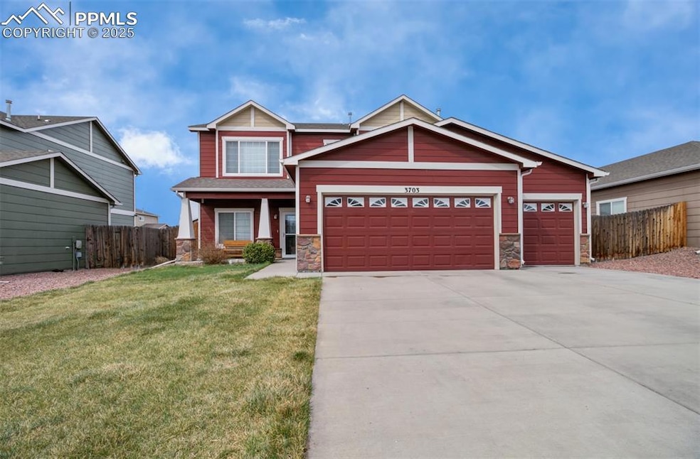 Craftsman house with stone siding, driveway, a garage, and covered porch