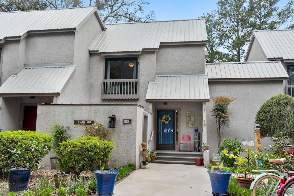 View of front facade featuring stucco siding and m