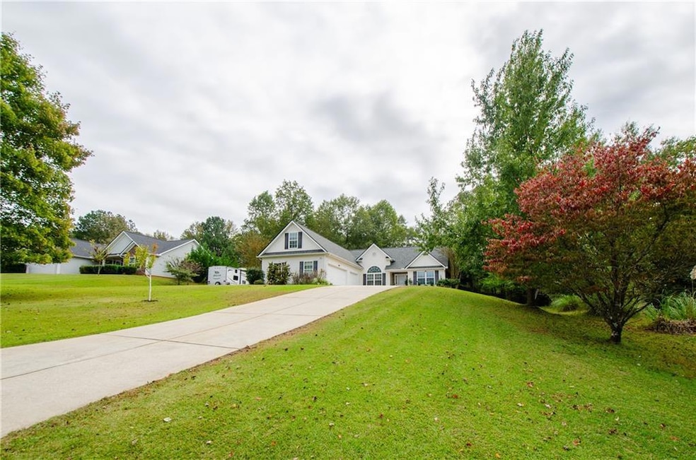 View of front of house featuring a front yard and concrete driveway