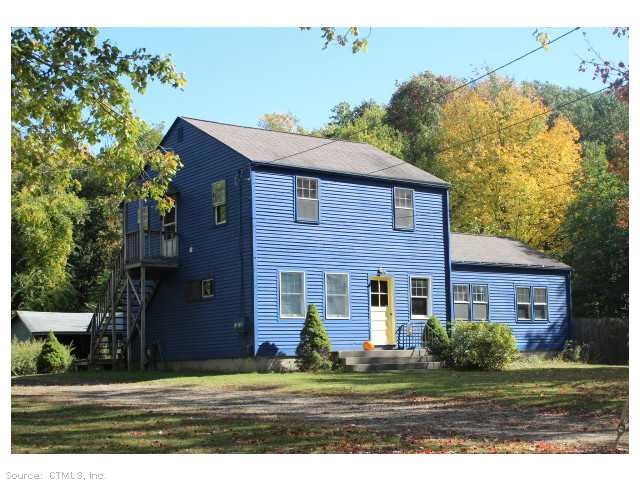 Exterior Front. Bright cobalt blue home is distinc