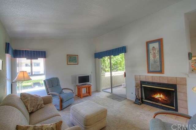 Sunny living room, wrap around balcony to bedroom.