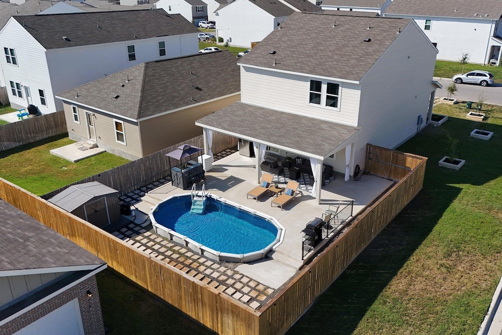 View of swimming pool with a patio, a fenced backyard, a residential view, and outdoor dining area