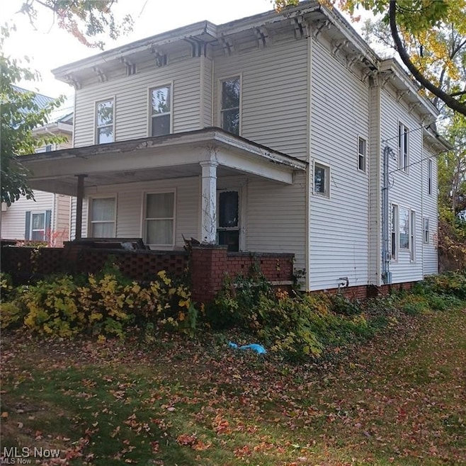 View of side of property featuring a porch