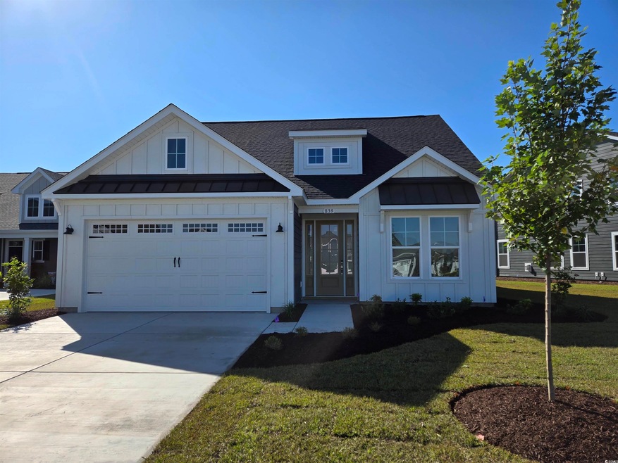 View of front facade with a garage and a front law
