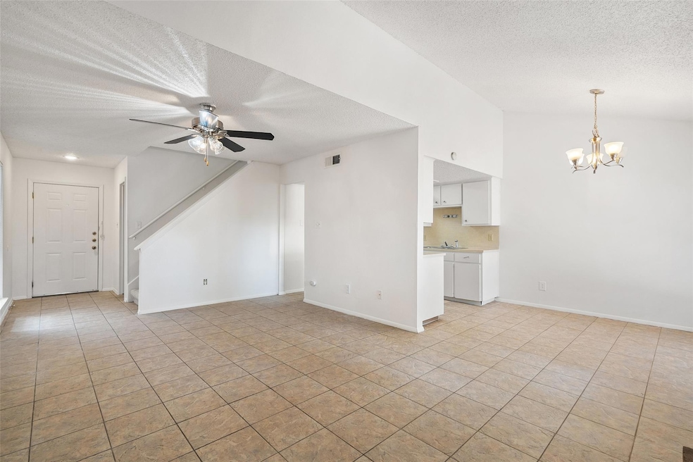 Unfurnished living room featuring a chandelier, a