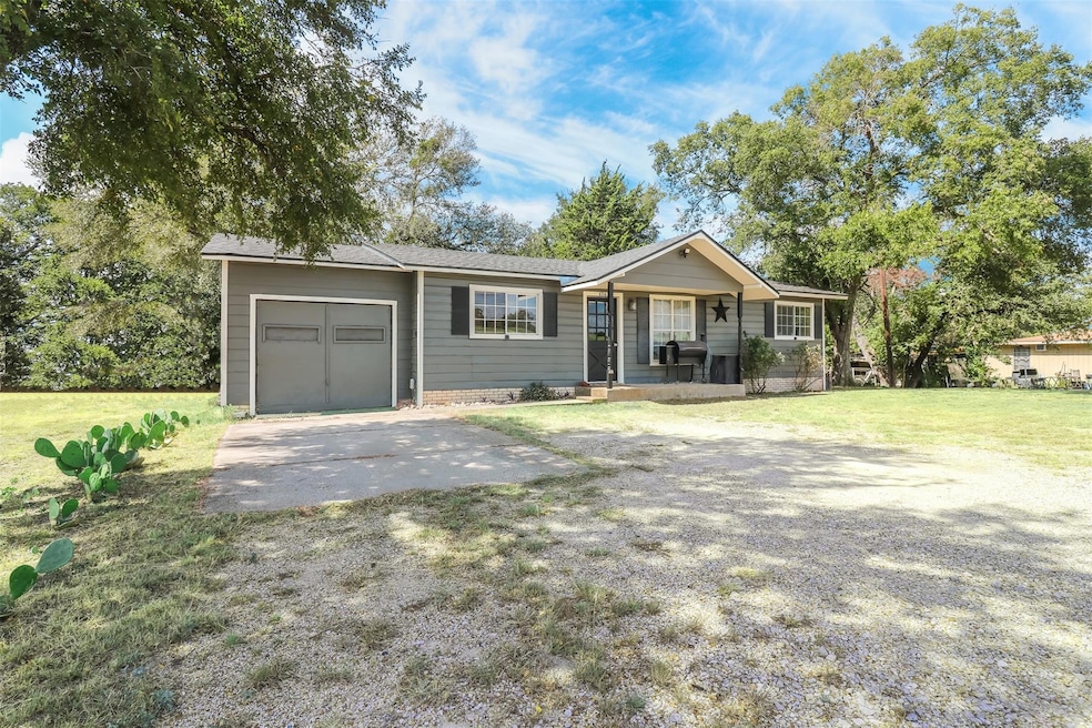 Single story home with covered porch, a front yard