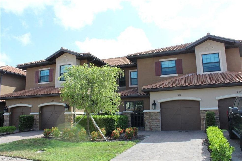 View of front facade with a garage, stucco siding,