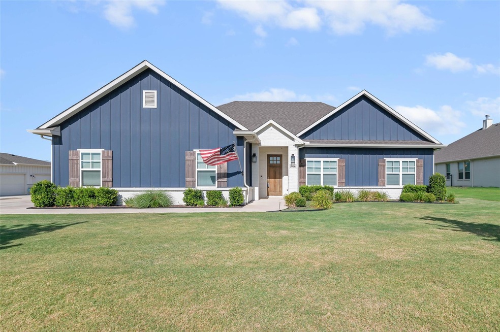 Street view of home.  Well manicured yard shows pr
