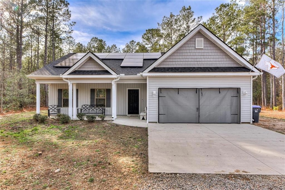 View of front of house with a garage, a shingled r