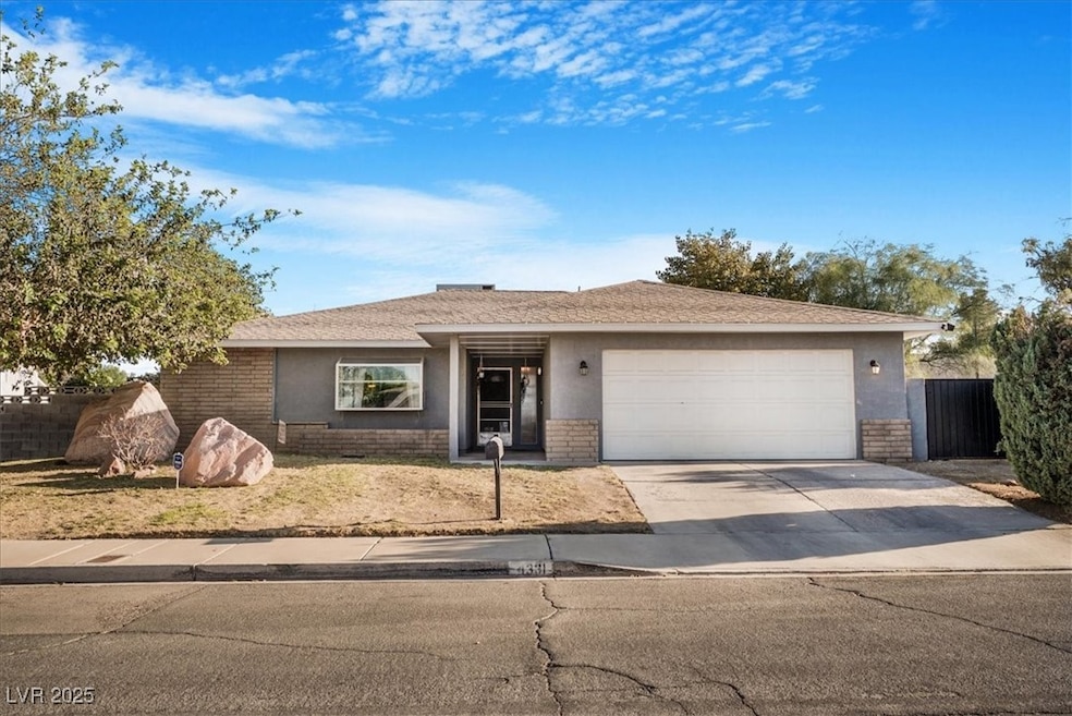 Ranch-style house with brick siding, concrete driveway, an attached garage, and stucco siding