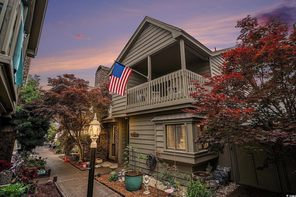 Back of house featuring a balcony and a chimney