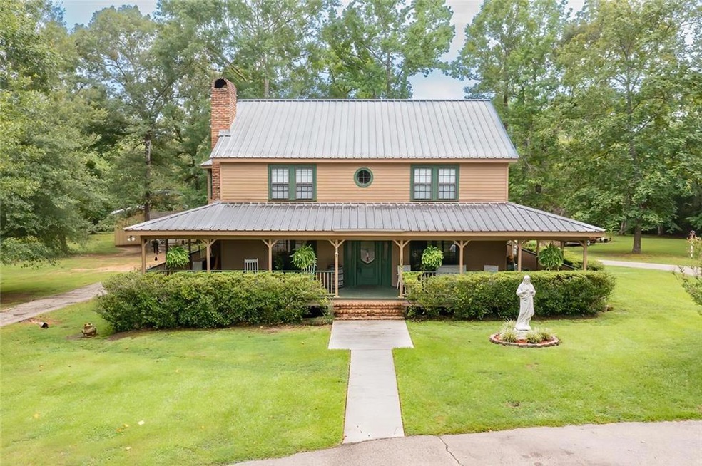Acadian with wrap around porch sitting on 5 acres