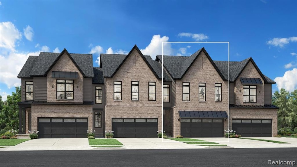 View of front of property featuring driveway, brick siding, and an attached garage