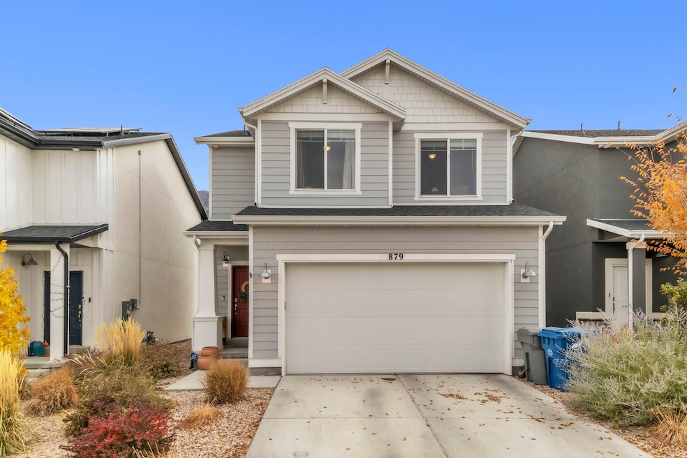 View of front of home with a garage and driveway