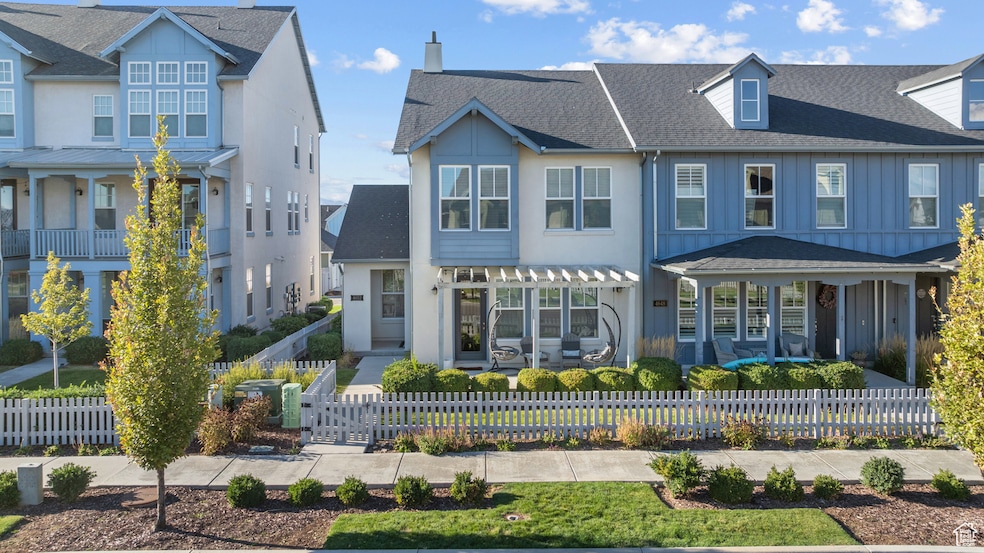 View of front of home with a fenced front yard and roof with shingles