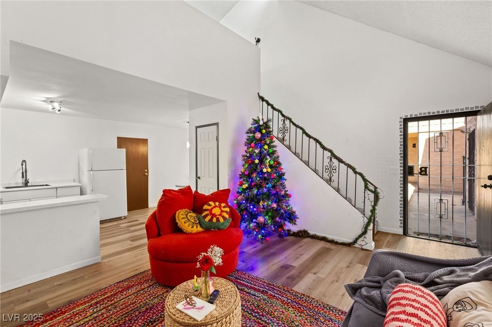 Living area featuring high vaulted ceiling, stairw