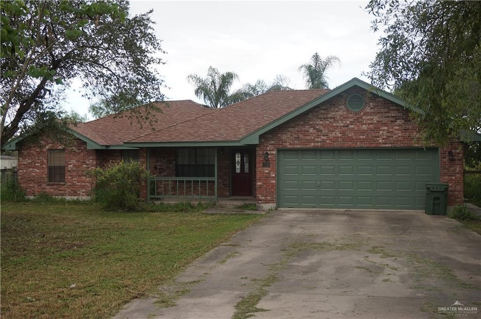 Single story home featuring a garage and a front lawn
