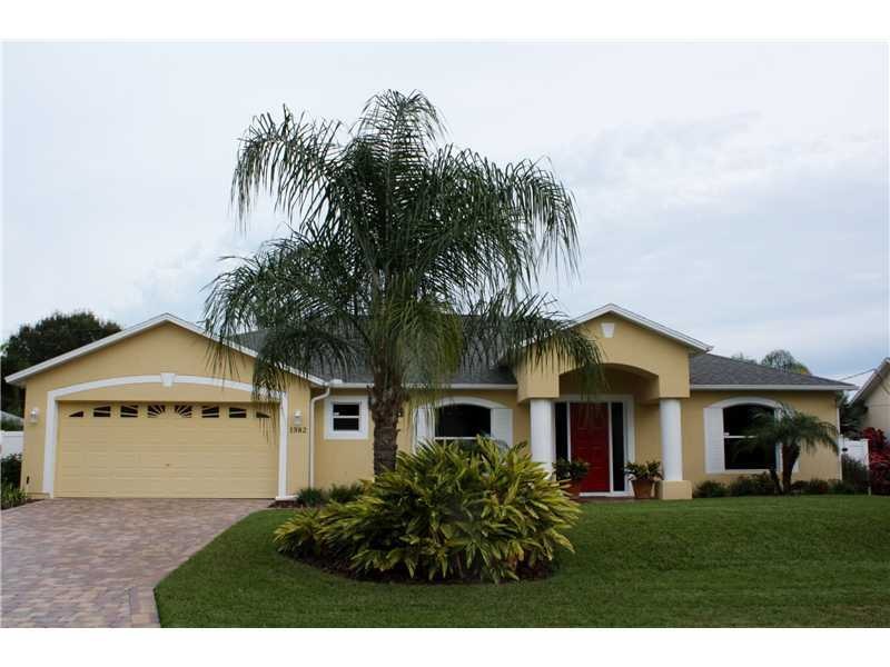 Exterior Front. Beautifully Landscaped Yard across