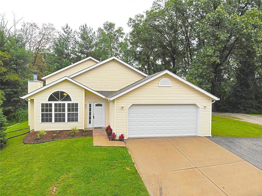 Updated exterior with extra parking pad along driveway.