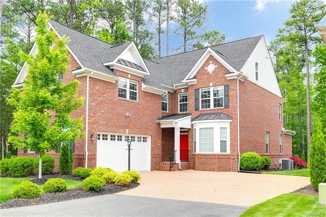 Brick and hardiplank exterior, meticulously landsc