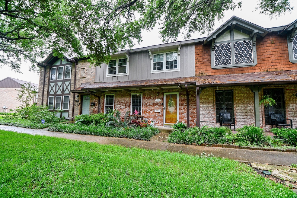 Charming two-story townhouse with a mix of brick a
