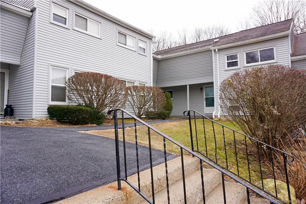 Stairway and sidewalk leading to condo to the righ