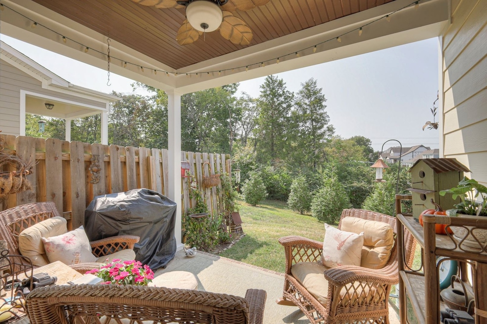 Enjoy the comforts of relaxing outside in the privacy of your covered back porch with a view of a tree lined backyard.