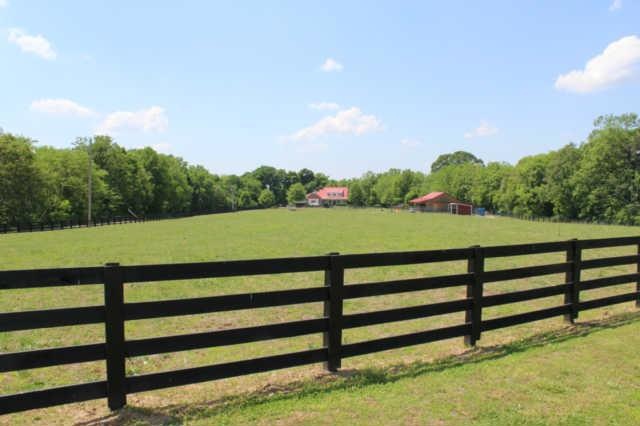 As you enter the front of the property you'll drive down the gravel road takin' in the sweet honey suckle 