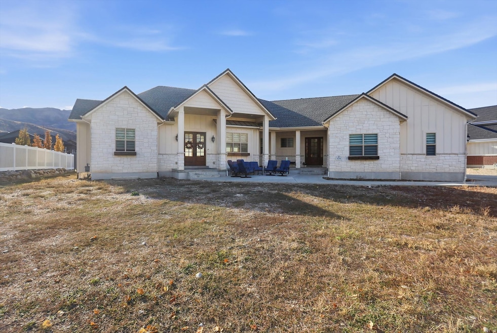 View of front of home with board and batten siding, stone siding, and a porch