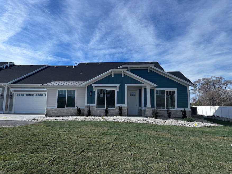 Craftsman-style house featuring stone siding and a garage